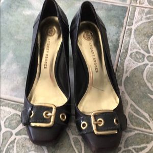 Brown heels with gold buckle.